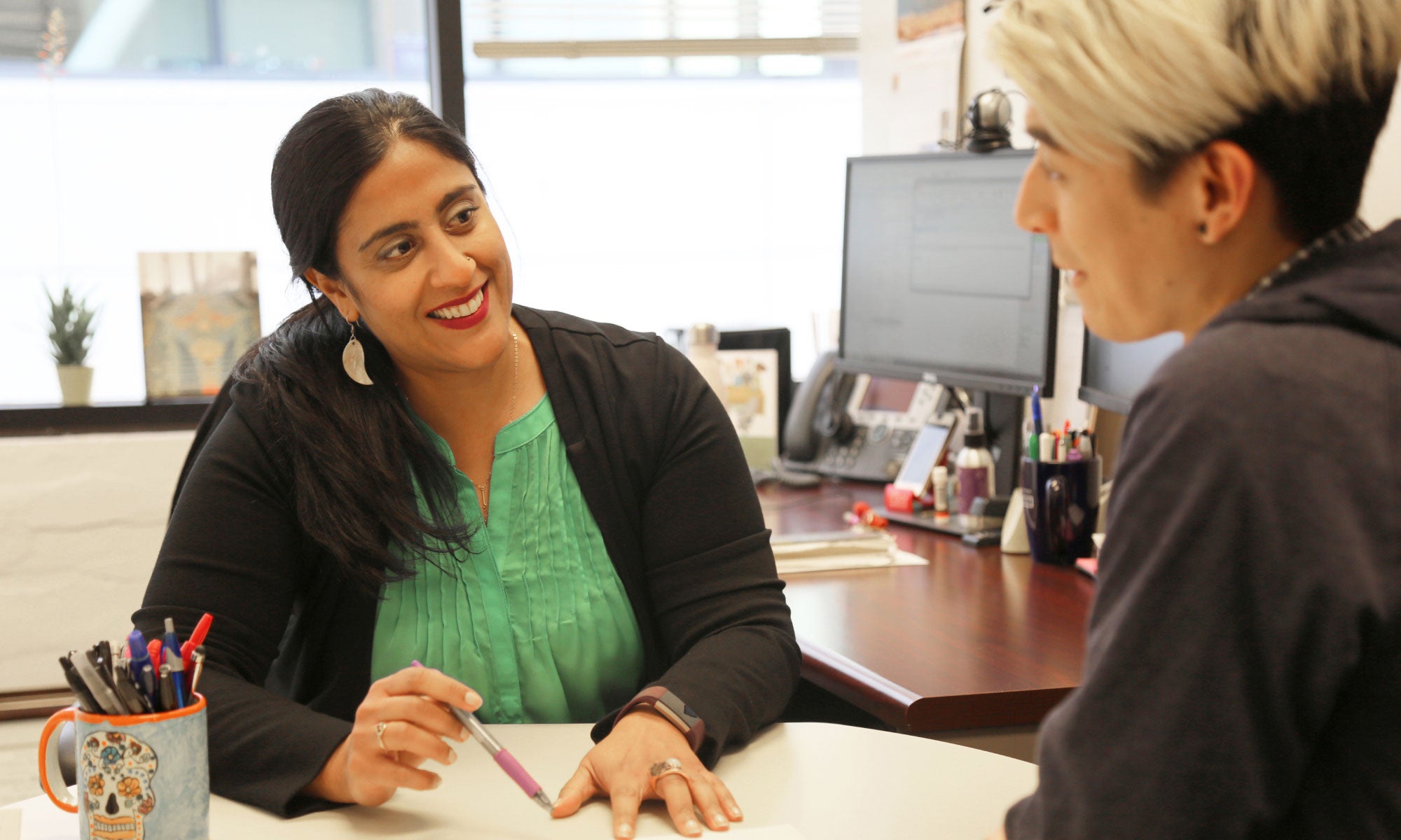 Enrollment advisor working with student in office.