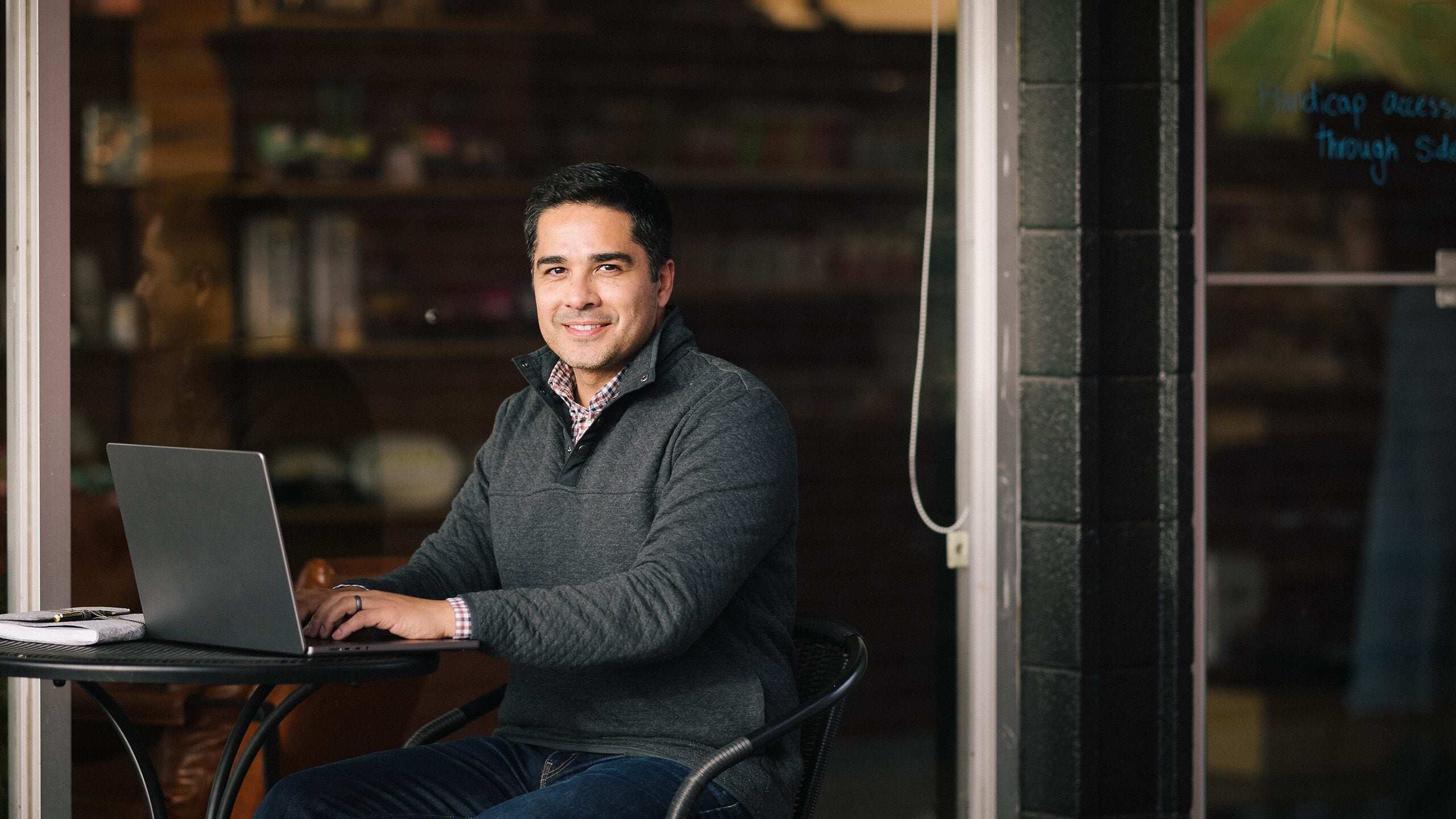 Man working on laptop outside.